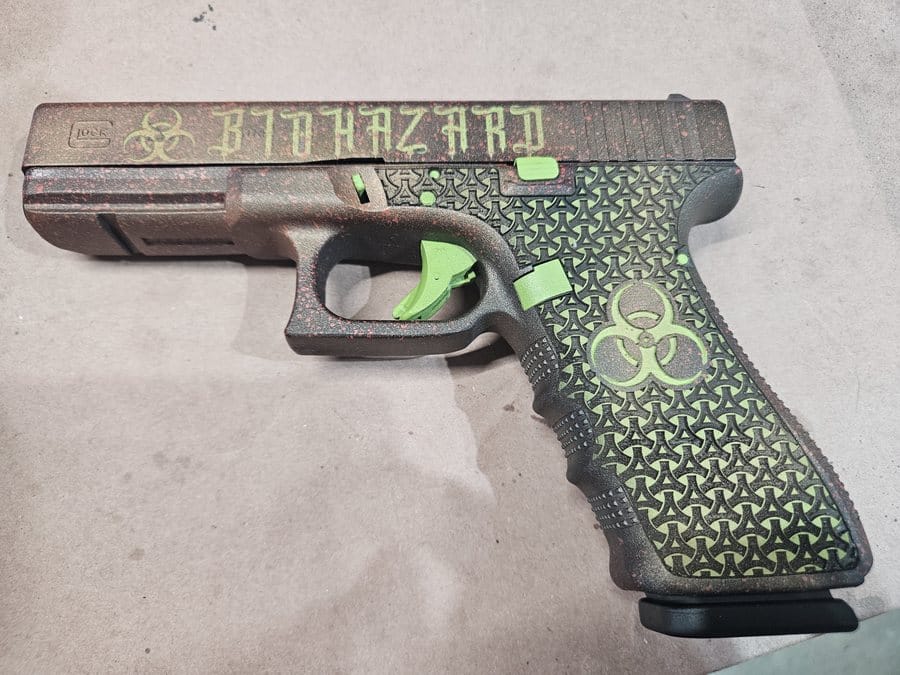 Custom Biohazard-themed Cerakote pistol with green accents