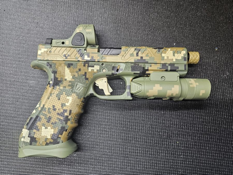 Digital camo Cerakote pistol with mounted light and optic