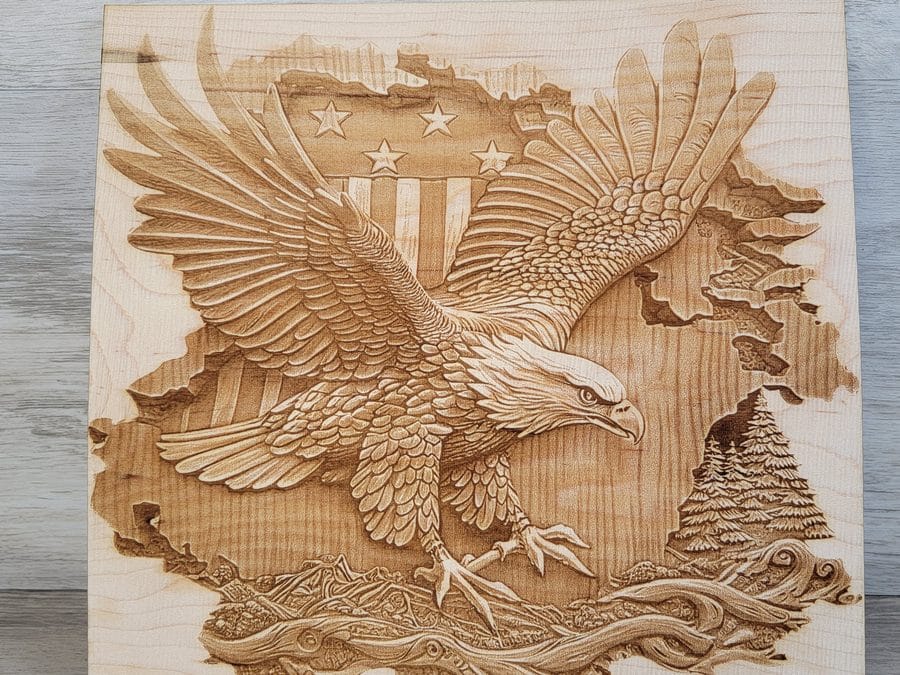 Detailed laser-engraved eagle scene on a wood panel
