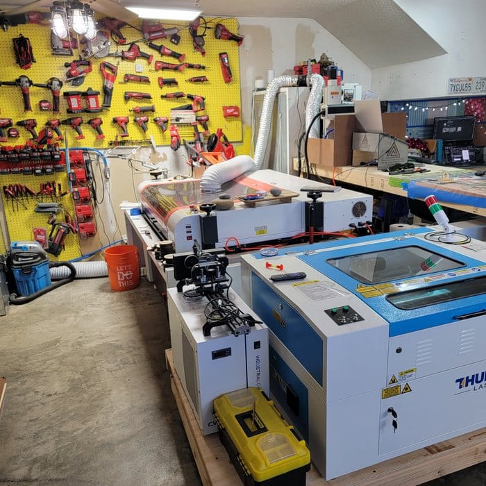 Shop interior with laser machines and tool wall
